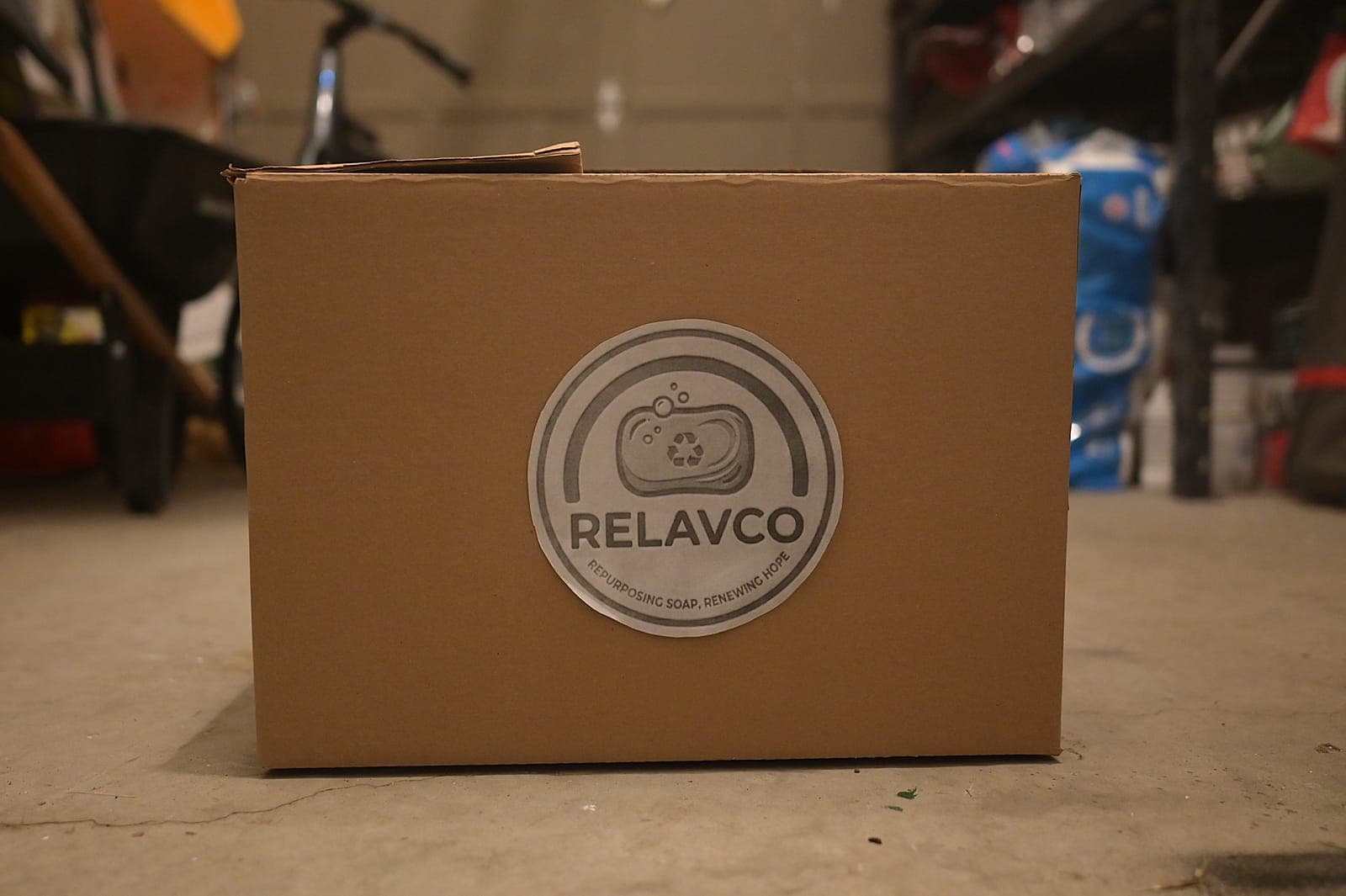 Video/photo: a Relavco volunteer handing wrapped bars to a shelter partner.